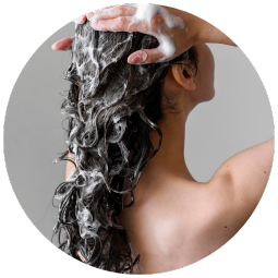 close up of backside of a woman washing her hair
